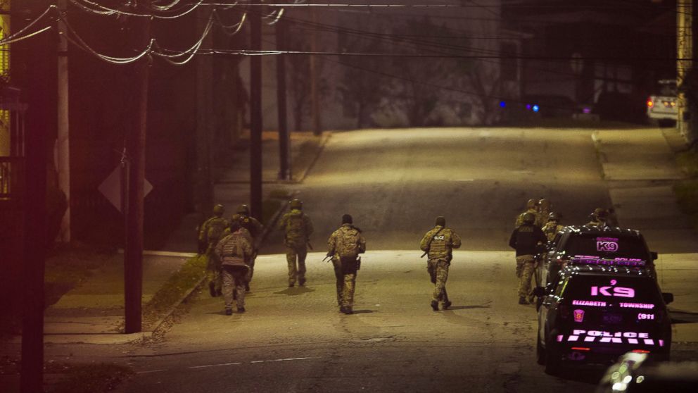 PHOTO: A SWAT team walks along a street in the neighborhood where a police officer was fatally shot Friday, Nov. 17, 2017, in New Kensington, Pa.