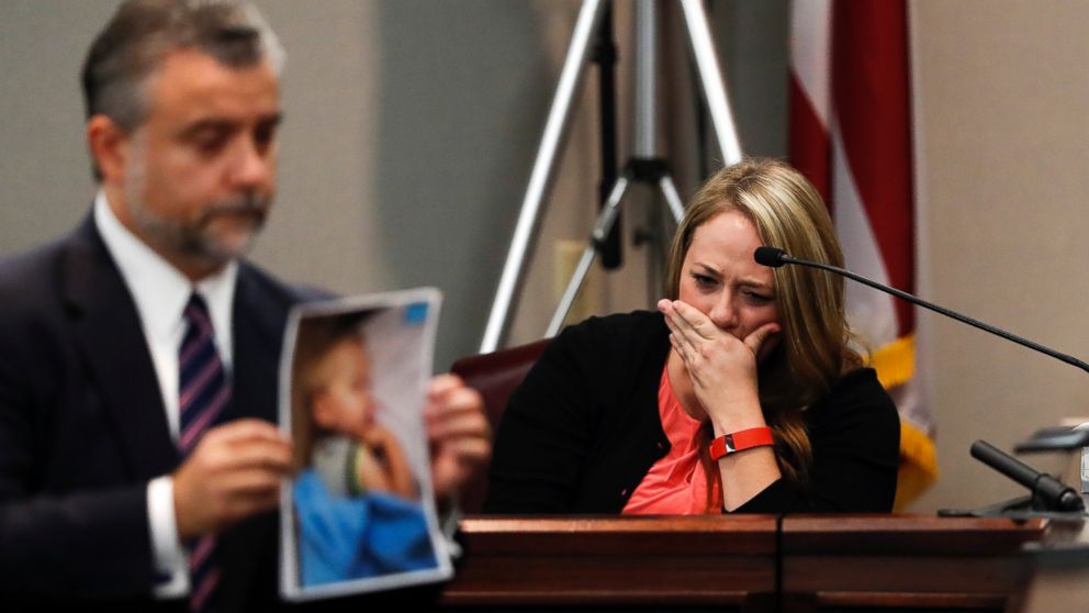 Leanna Taylor cries as defense attorney Maddox Kilgore shows the jury a picture of her son Cooper during a murder trial for her ex-husband Justin Ross Harris who is accused of intentionally killing Cooper in June 2014 by leaving him in the car in suburban Atlanta, Oct. 31, 2016, in Brunswick, Georgia. 