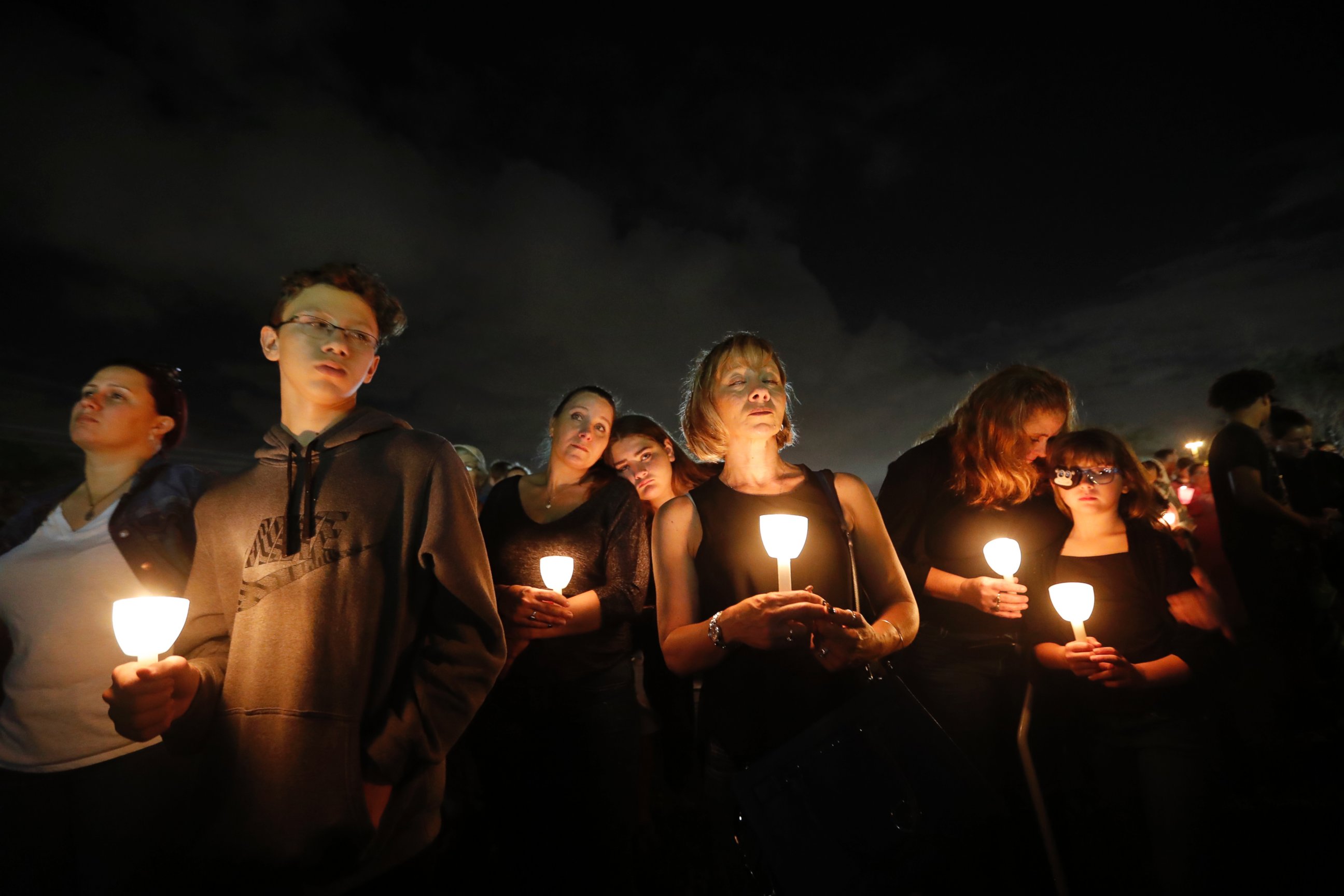 People participate in a candlelight vigil in memory of the 17 students and faculty who were killed in the Wednesday mass shooting at Marjory Stoneman Douglas High School in Parkland, Fla., Monday, Feb. 19, 2018.