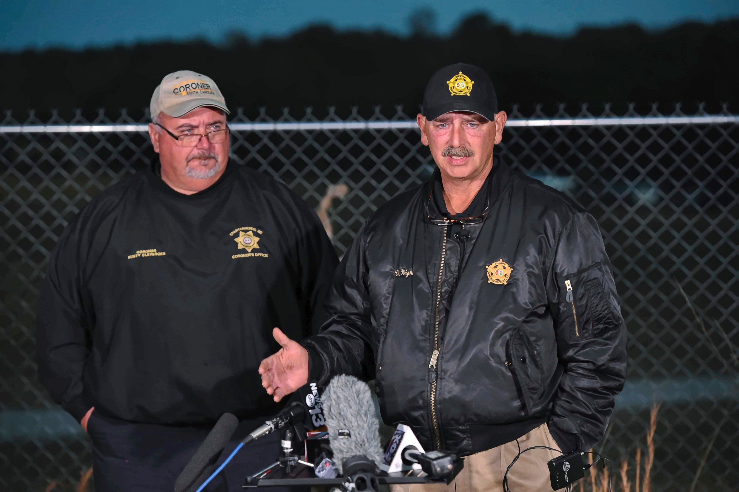 PHOTO: Spartanburg County Sheriff Chuck Wright, right, and Spartanburg County Coroner Rusty Clevenger hold a news conference in front of Todd Kohlhepp's property in Woodruff, S.C., Nov. 6, 2016.