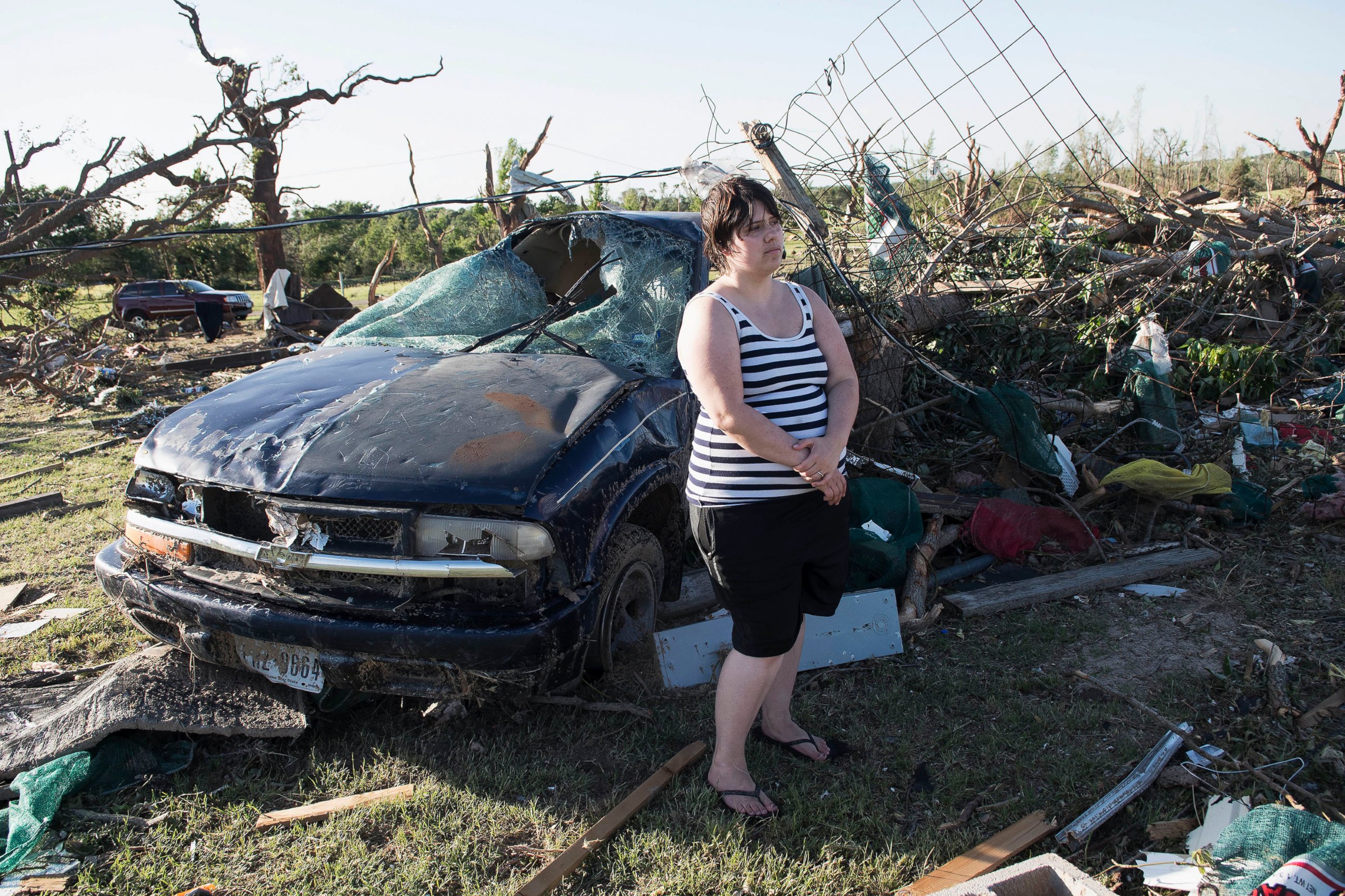 PHOTO: Kimberly Chandler stands by her destroyed truck and debris from her home in Canton, Texas, April 30, 2017. Deadly tornadoes hit several small towns in East Texas, including Canton.