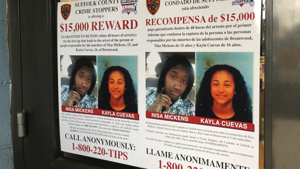 A poster at a Suffolk County police precinct in Bay Shore, N.Y., offers a $15,000 reward for information in the slayings of Nisa Mickens and Kayla Cuevas, Oct. 24, 2016. On March 2, 2017, federal agents said that they have caught the members of a violent El Salvadoran street gang who killed three teenagers last year, including the two girls who were inseparable best friends.