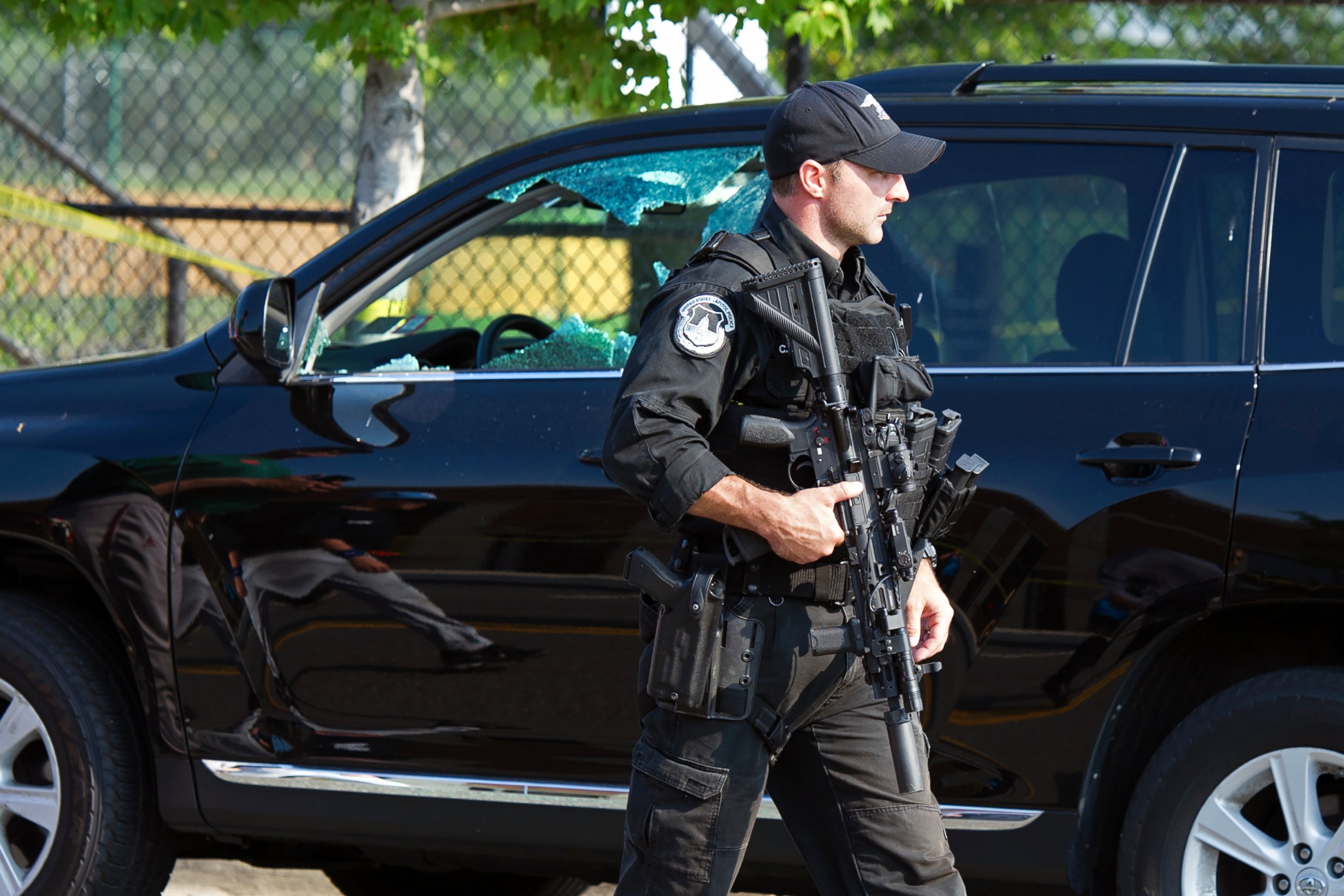 PHOTO: A Capitol Hill Police officer walks past an automobile with the driver's window damaged at the scene of a shooting in Alexandria, Va., June 14, 2017, where House Majority Whip Steve Scalise of La. was shot at a Congressional baseball practice.  