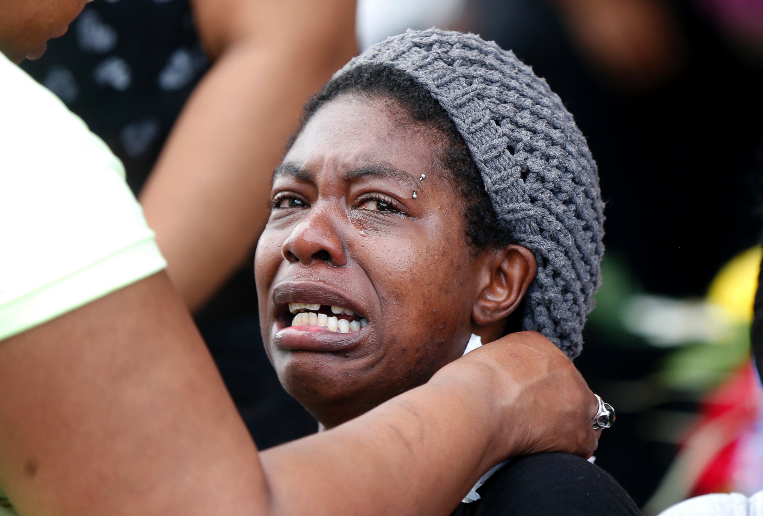 PHOTO: Tawandra Carr, who said she was best friends with Alton Sterling, is comforted as people gather outside the Triple S convenience store in Baton Rouge, La., Wednesday, July 6, 2016. 