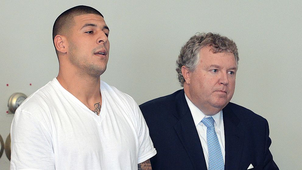 Former New England Patriots tight end Aaron Hernandez, left, stands with his attorney Michael Fee, right, during arraignment in Attleboro District Court on June 26, in Attleboro, Mass., where Hernandez was charged with murdering Odin Lloyd.  