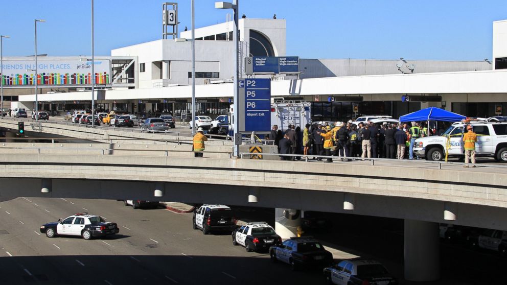 Police, emergency response vehicles and officials are positioned outside Terminal 3 at Los Angeles International Airport on Nov. 1, 2013. Shots were fired Friday at Los Angeles International Airport, prompting authorities to evacuate a terminal and stop flights. 
