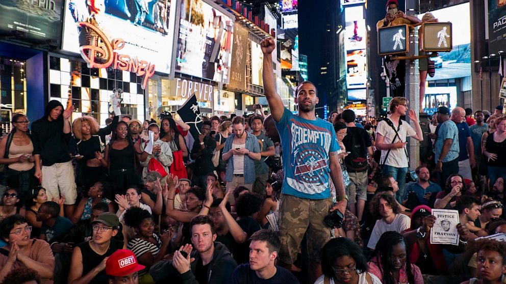 Marchers gather together on Times Square, Sunday, July 14, 2013, in New York, for a protest against the acquittal of volunteer neighborhood watch member George Zimmerman in the 2012 killing of 17-year-old Trayvon Martin in Sanford, Fla.
