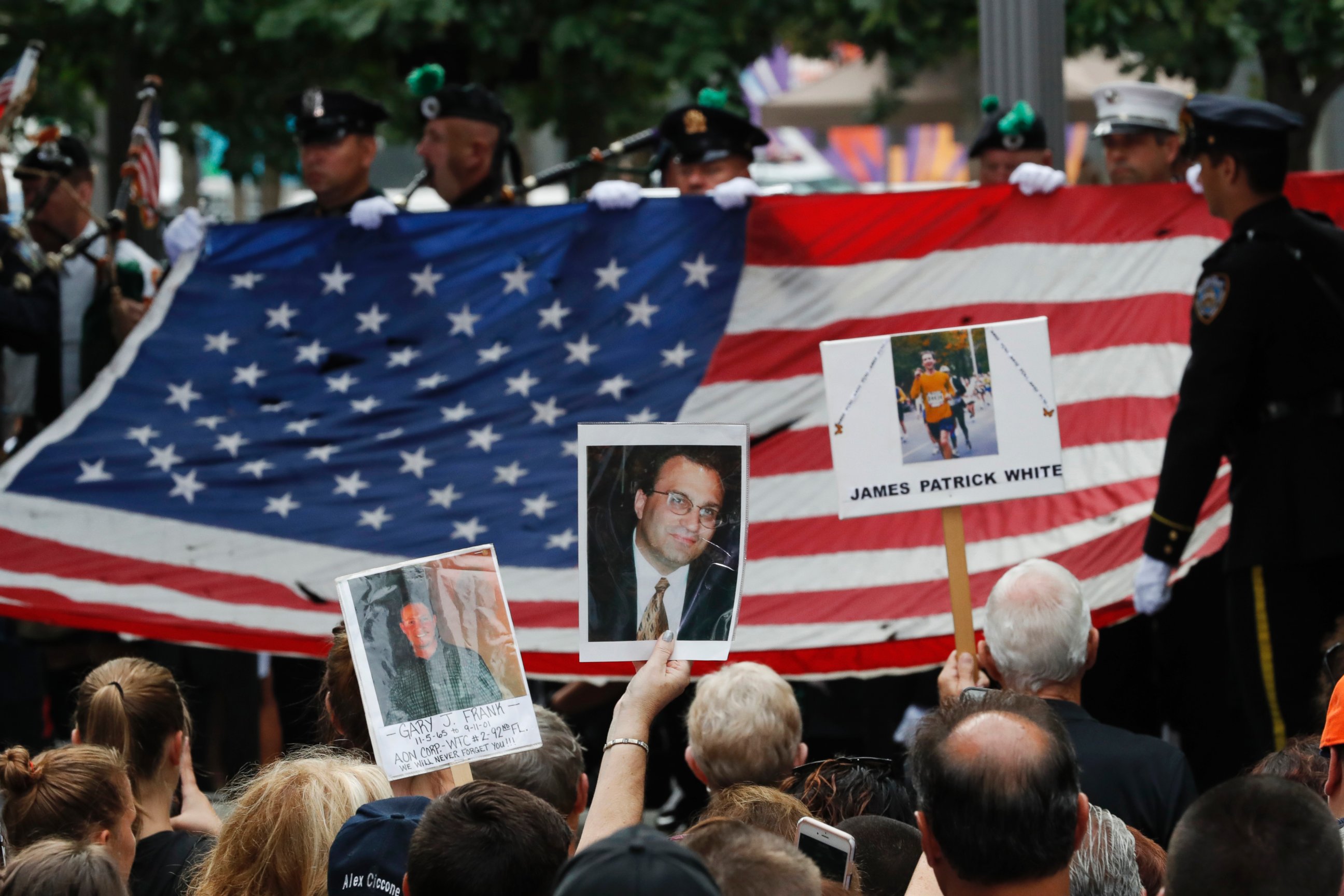 PHOTO: Mourners hold photos of their loved ones during the 15th anniversary of the attacks of the World Trade Center at the National September 11 Memorial, Sept. 11, 2016, in New York.