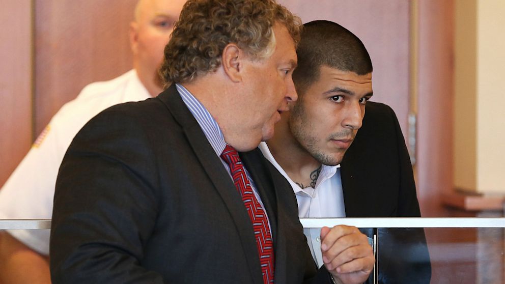 Former New England Patriots player Aaron Hernandez, right, listens to attorney Michael Fee during his arraignment in superior court, Sept. 6, 2013, in Fall River, Mass.