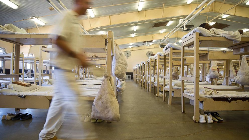 PHOTO: A prisoner walks near his crowded living area in Elmore Correctional Facility in Elmore, Ala., June 18, 2015.