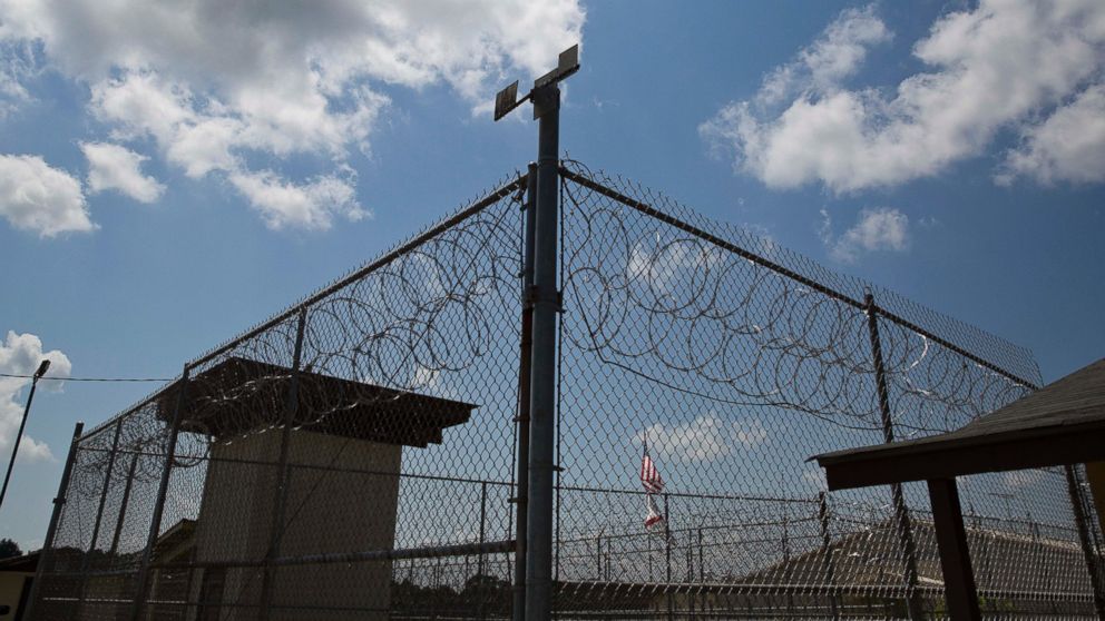 In this June 18, 2015, photo, a fence stands at Elmore Correctional Facility in Elmore, Ala.