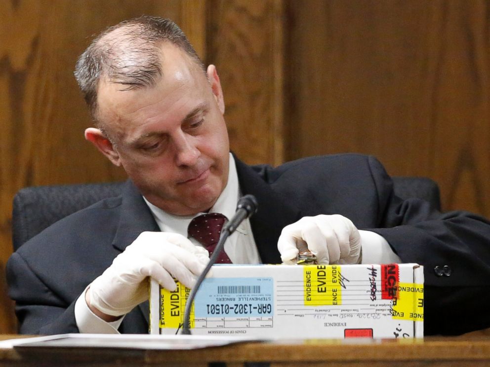 PHOTO: Texas Ranger Michael Adcock opens boxed evidence as he testifies during the second day of former Marine Cpl. Eddie Ray Rouths capital murder trial in Stephenville, Texas, Thursday, Feb. 12, 2015.