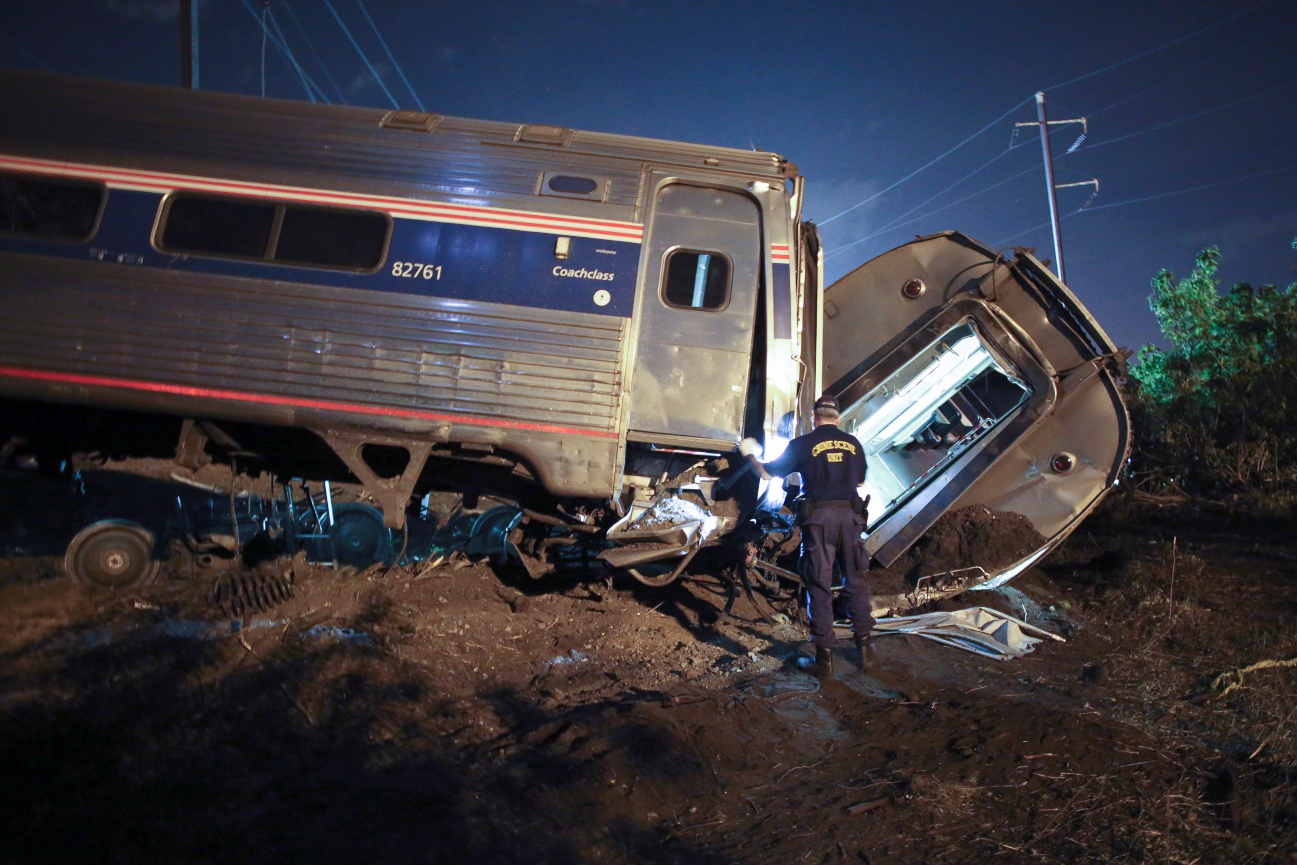 PHOTO: A crime scene investigator looks inside a train car after a train wreck, May 12, 2015, near Philadelphia.