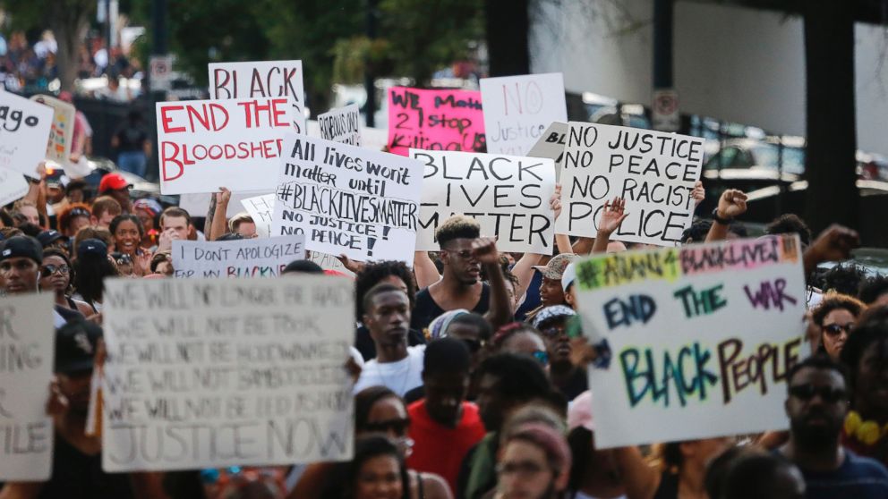 PHOTO: Demonstrators march through downtown Atlanta to protest the shootings of two black men by police officers, Friday, July 8, 2016.