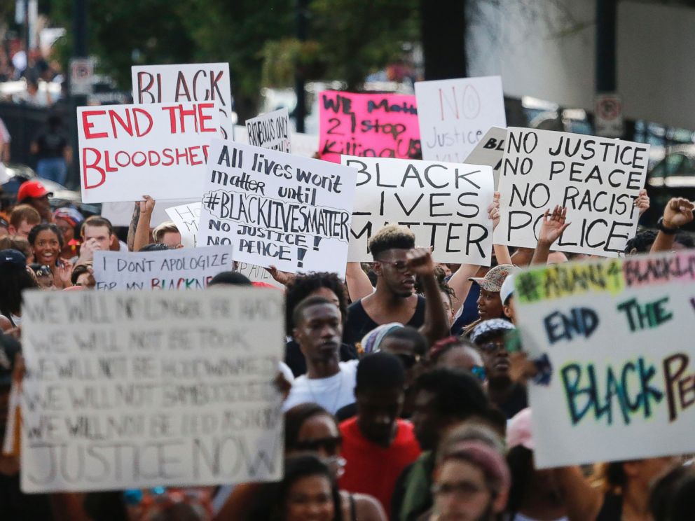PHOTO: Demonstrators march through downtown Atlanta to protest the shootings of two black men by police officers, Friday, July 8, 2016.