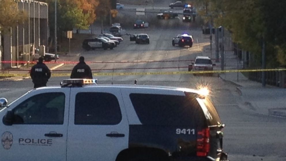 Police tape marks off the scene after authorities shot and killed a man who they say opened fire on the Mexican Consulate, police headquarters and other downtown buildings on Nov. 28, 2014 in Austin, Texas. In the distance, police cars surround the suspect's vehicle parked near the Interstate 35 overpass.