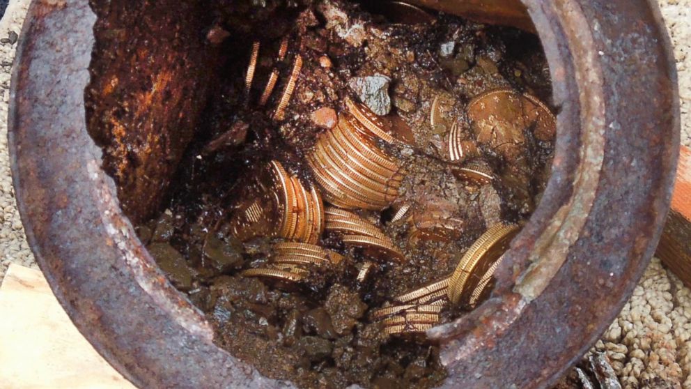 This image provided by the Saddle Ridge Hoard discoverers via Kagin's, Inc., shows one of the six decaying metal canisters filled with 1800s-era U.S. gold coins unearthed in California by two people who want to remain anonymous. The value of the "Saddle Ridge Hoard" treasure trove is estimated at $10 million or more. 