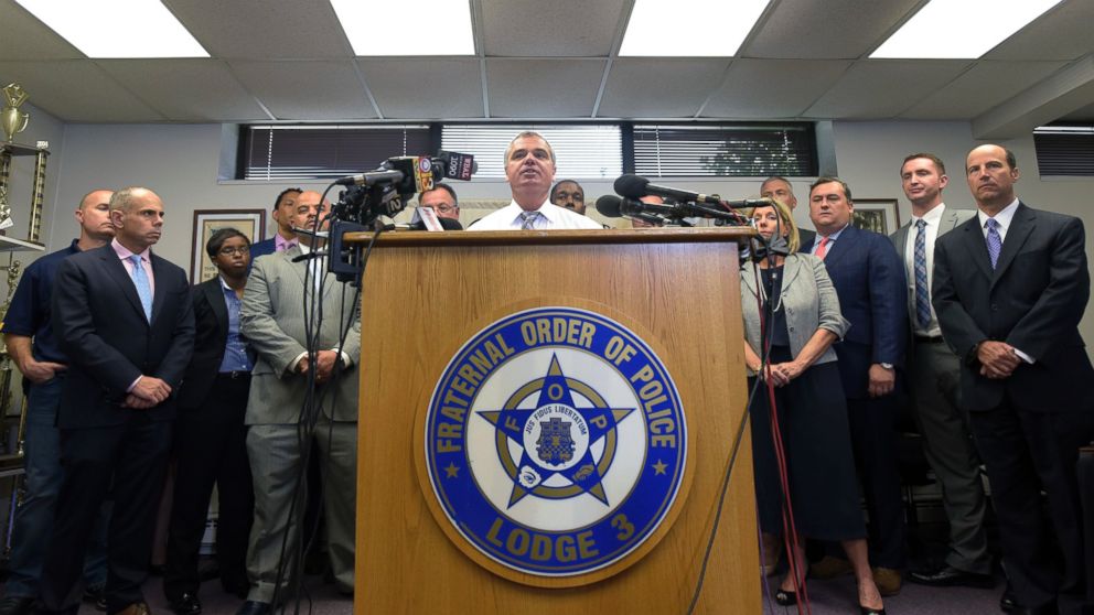Gene Ryan, center, president of the Baltimore Fraternal Order of Police, flanked by attorneys and accused police officers, speaks during a news conference after prosecutors dropped remaining charges against the three Baltimore police officers who were awaiting trial in Freddie Gray's death, in Baltimore, July 27, 2016. 