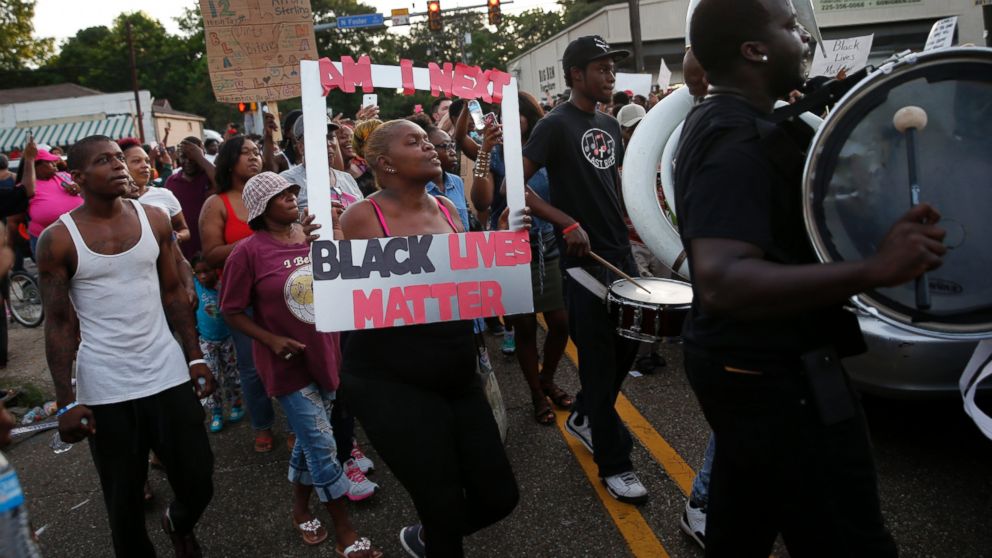 PHOTO: People follow a brass band through the street after a vigil for Alton Sterling, who was shot and killed during a scuffle with police officers, outside the Triple S convenience store in Baton Rouge, La., Wednesday, July 6, 2016. 