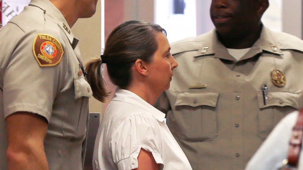 Tulsa police officer Betty Shelby is led from the Tulsa County Sheriff's office into a courtroom in the Tulsa County courthouse, in Tulsa, Okla., Sept. 30, 2016.