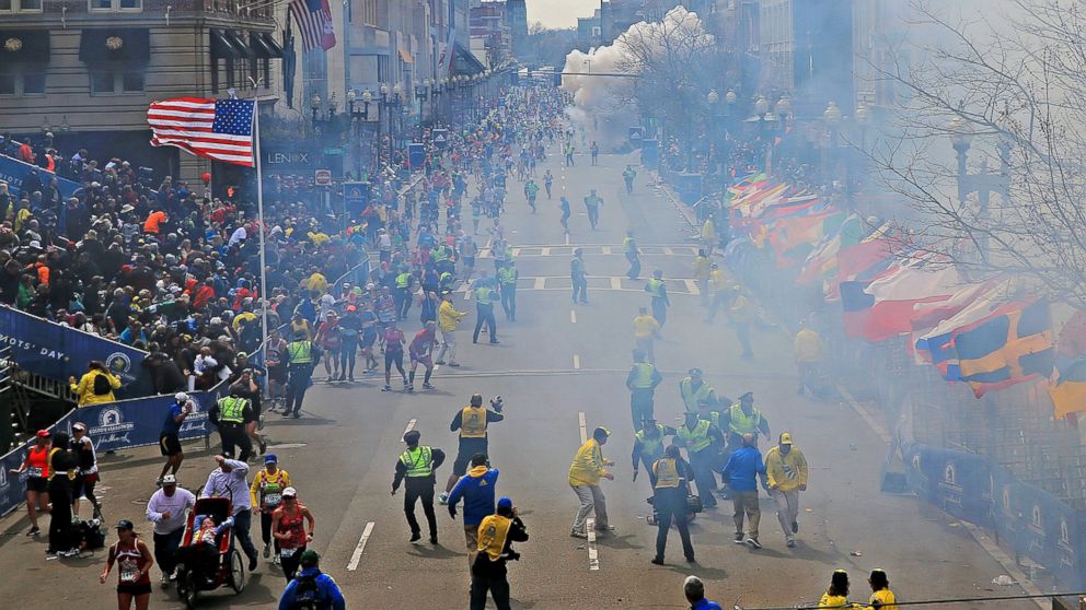 People react as an explosion goes off near the finish line of the 2013 Boston Marathon in Boston on April 15, 2013.