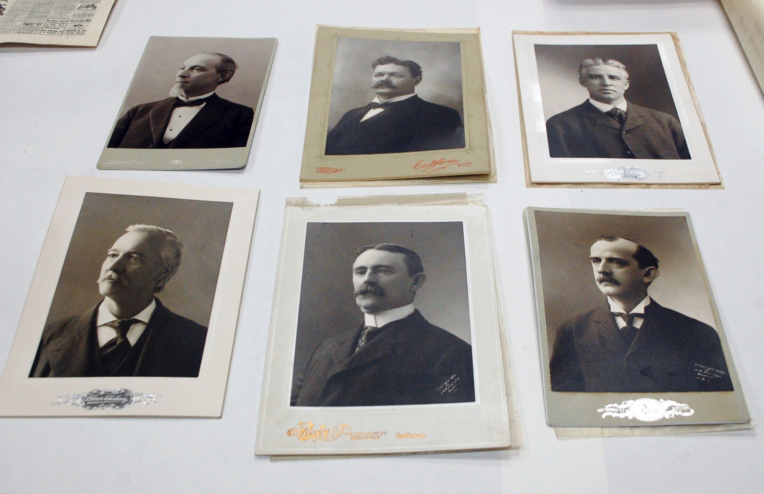 PHOTO: Photographs of city and state elected officials, including Boston Mayor Thomas Norton Hart at top left, are displayed after they were taken from a 1901 time capsule in Boston.