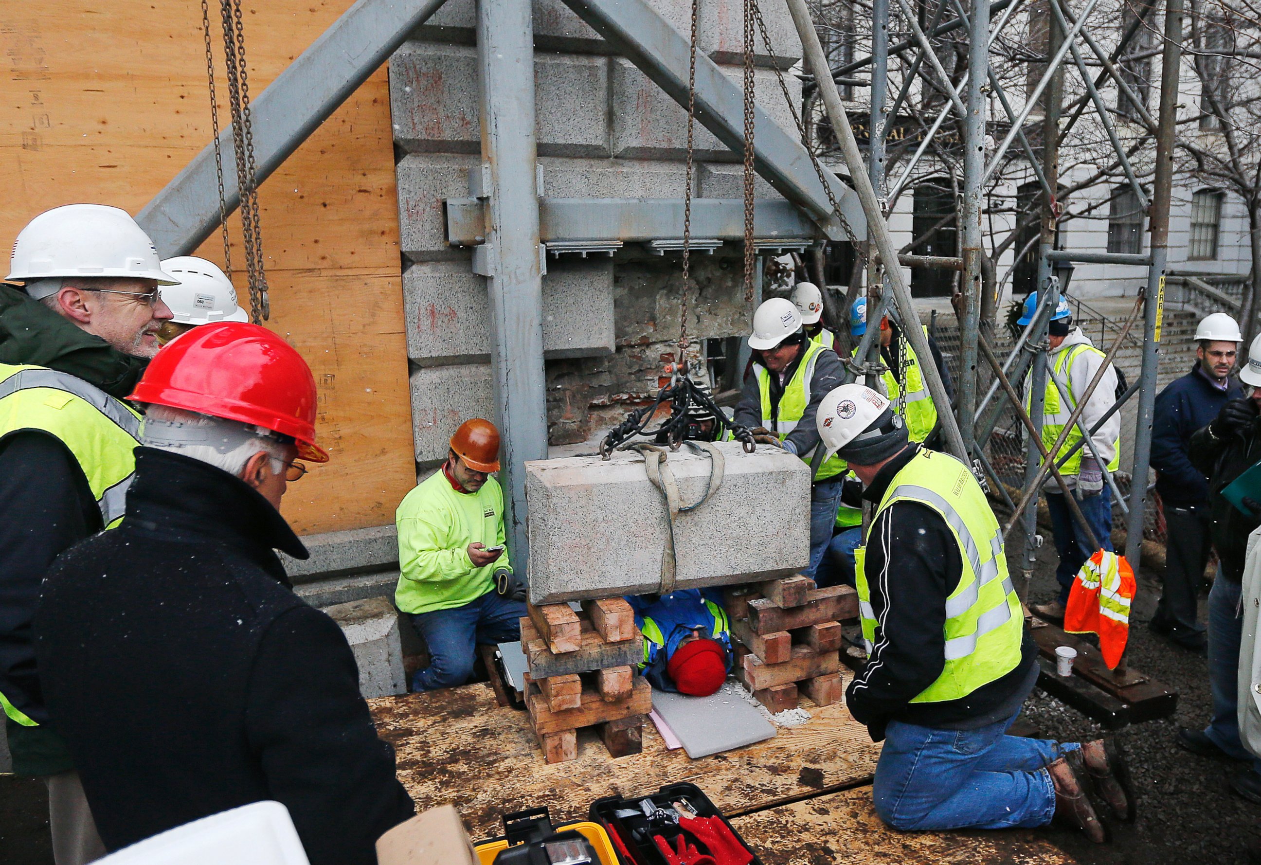 PHOTO: Massachusetts officials work to remove a time capsule in the cornerstone of the Statehouse in Boston,  Dec. 11, 2014. 