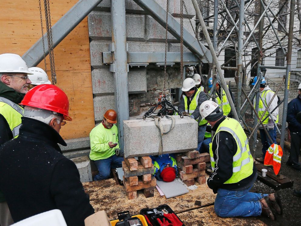 PHOTO: Massachusetts officials work to remove a time capsule in the cornerstone of the Statehouse in Boston, Dec. 11, 2014.