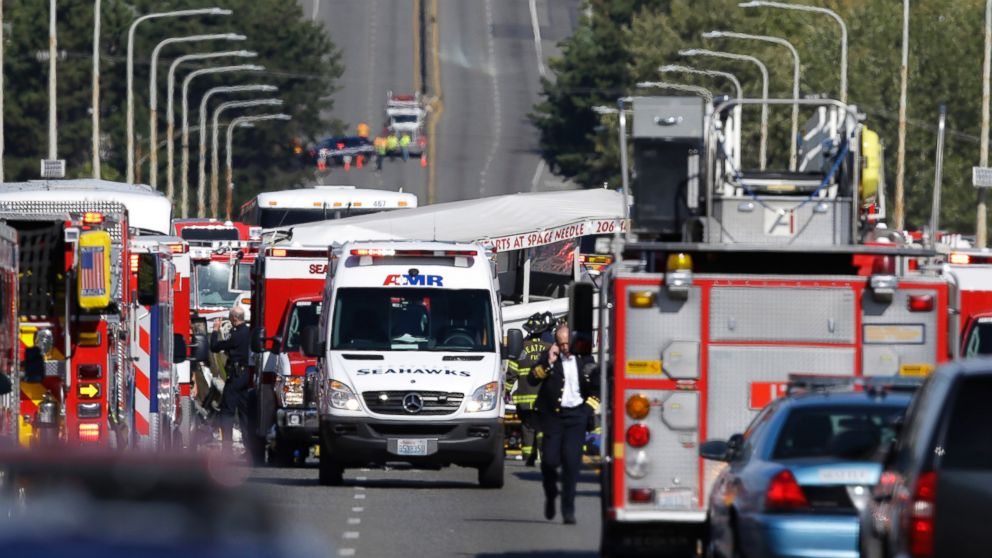 A Ride the Ducks tour bus that was involved in a crash with several other vehicles can be seen behind an ambulance as officials respond, Sept. 24, 2015 in Seattle. 