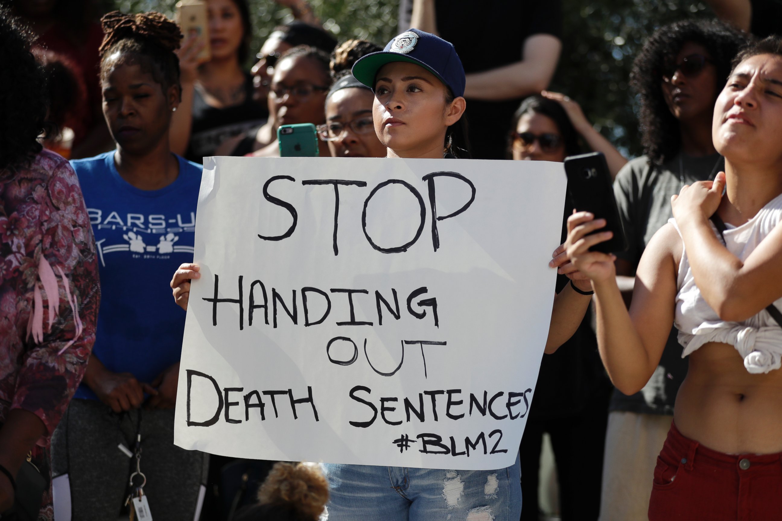 PHOTO: People hold signs during a protest in front of the El Cajon Police Department Wednesday, Sept. 28, 2016, in El Cajon, Calif.