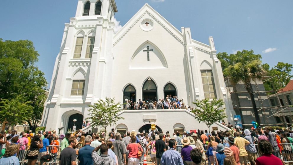 PHOTO: People stand outside as parishioners leave the Emanuel A.M.E. Church, Sunday, June 21, 2015, in Charleston, S.C.