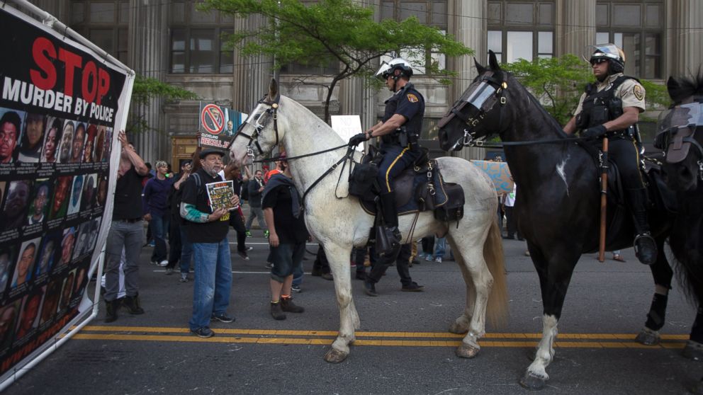 Mounted police follow demonstrators as they march through downtown during a protest against the acquittal of Michael Brelo, a patrolman charged in the shooting deaths of two unarmed suspects, Saturday, May 23, 2015, in Cleveland.