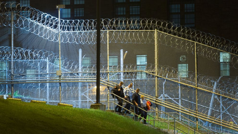 PHOTO: Corrections officers walk next to a fence covered in razor wire as they leave work at Clinton Correctional Facility in Dannemora, N.Y., June 15, 2015.