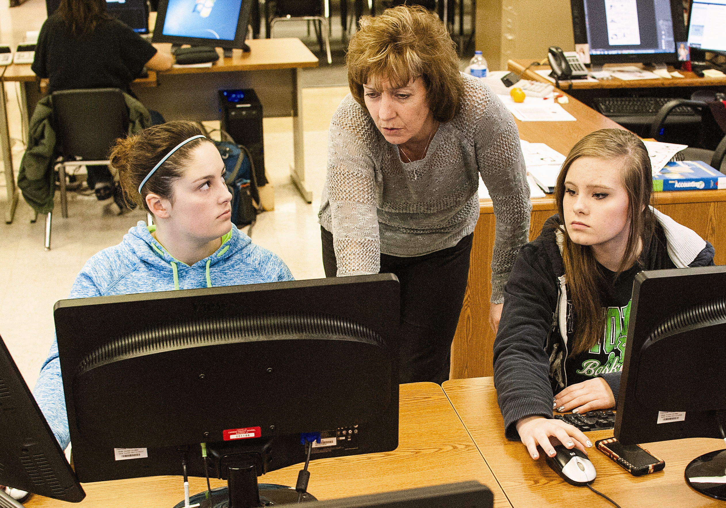 PHOTO: Rawlins High School teacher Valerie Jennings, center, gives advice to Paden Waller, left, and Lexie Michel, who are coding their own 3D Frogger game, in Rawlins, Wyo., on Dec. 11, 2014.