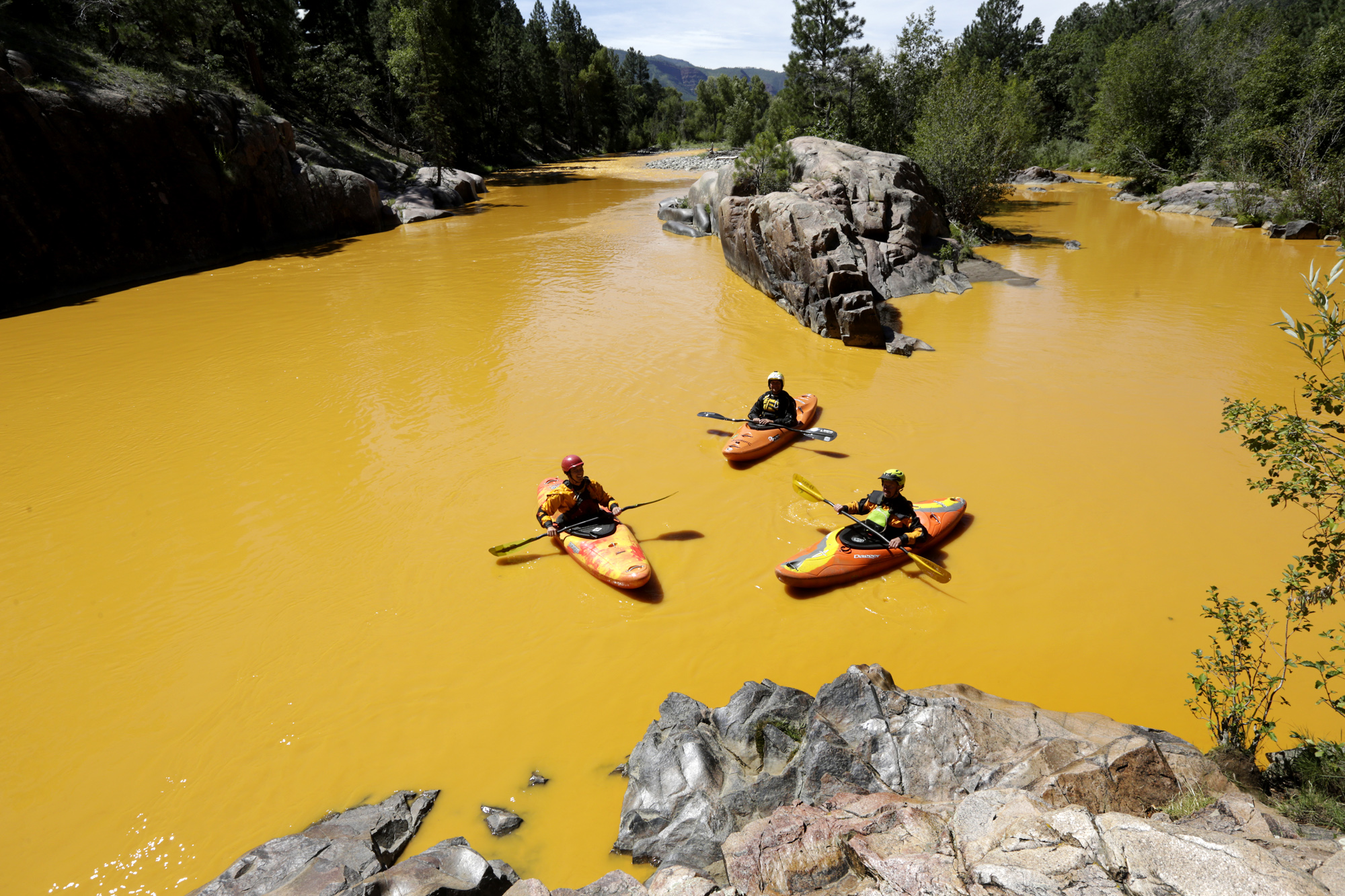 PHOTO: In this Thursday, Aug. 6, 2015 file photo, people kayak in the Animas River near Durango, Colo., in water colored yellow from a mine waste spill. 