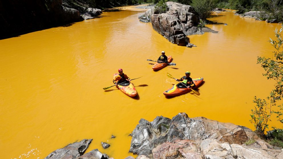 PHOTO: In this Thursday, Aug. 6, 2015 file photo, people kayak in the Animas River near Durango, Colo., in water colored yellow from a mine waste spill. 