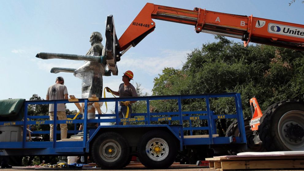 A statue of Confederate President Jefferson Davis is moved from its location in front of the school's main tower on the University of Texas campus, Aug. 30, 2015, in Austin, Texas.