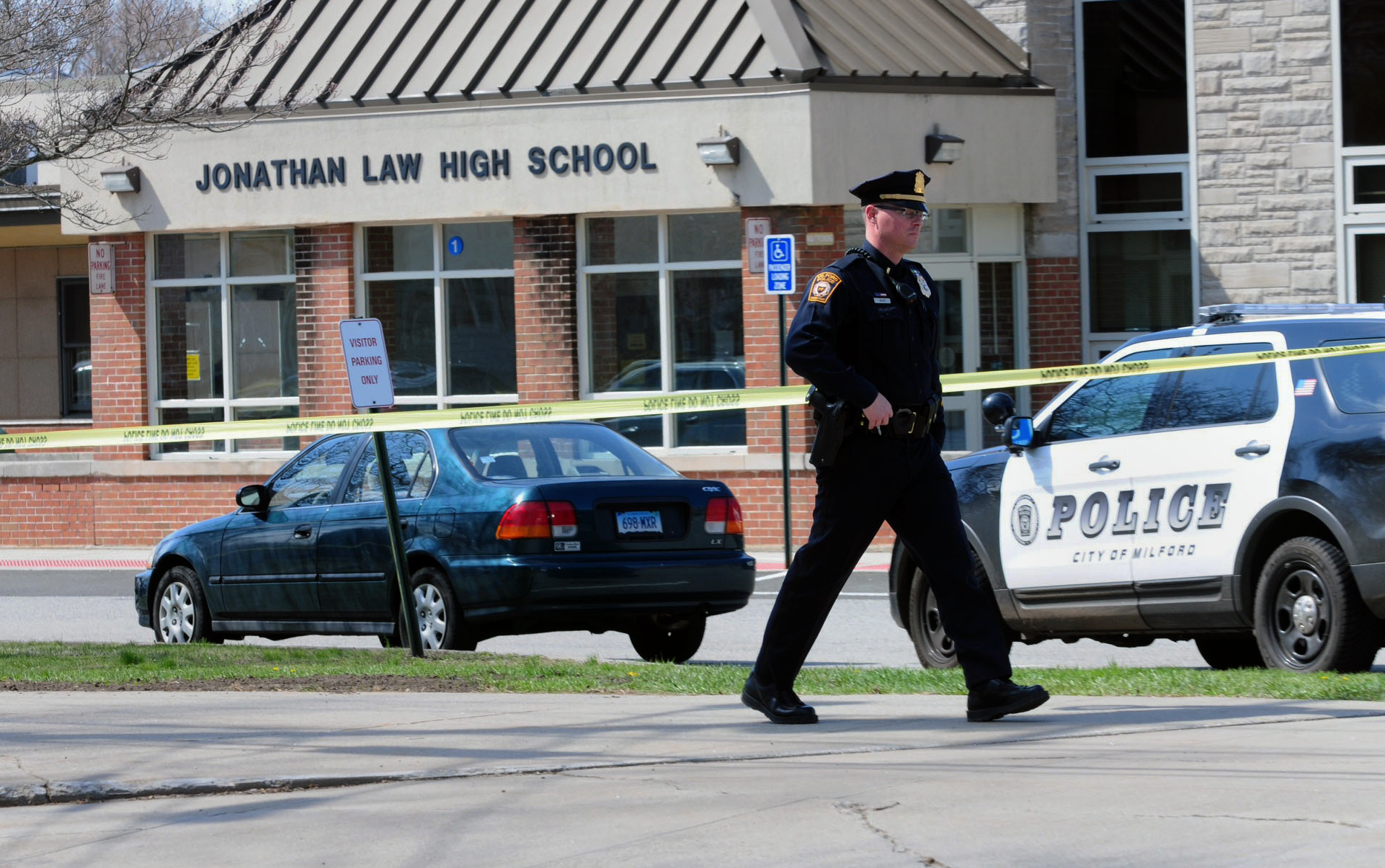 PHOTO: Police remain on scene at Jonathan Law High School after a 16-year-old girl was stabbed to death in Milford, Conn., April 25, 2014.