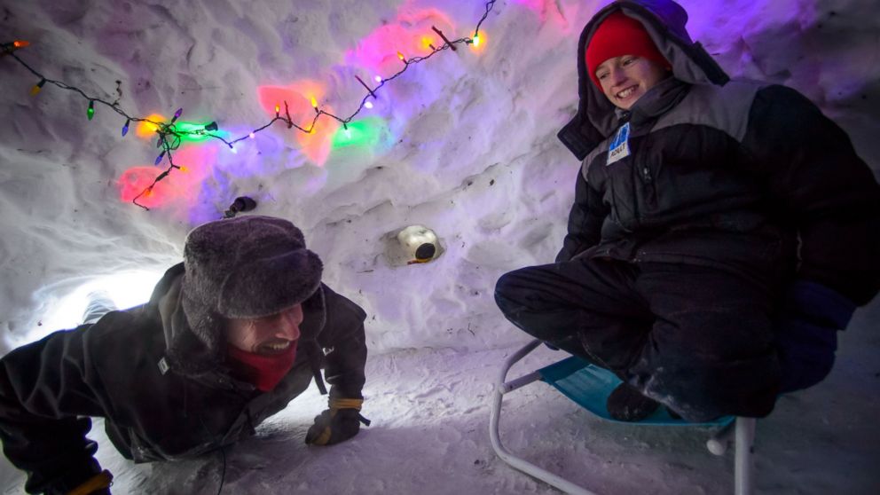 Eli Esch, right, and his father Tom enjoy the snow fort and igloo they built over the last few weeks, on  Jan. 6, 2014 in Minneapolis, Min.