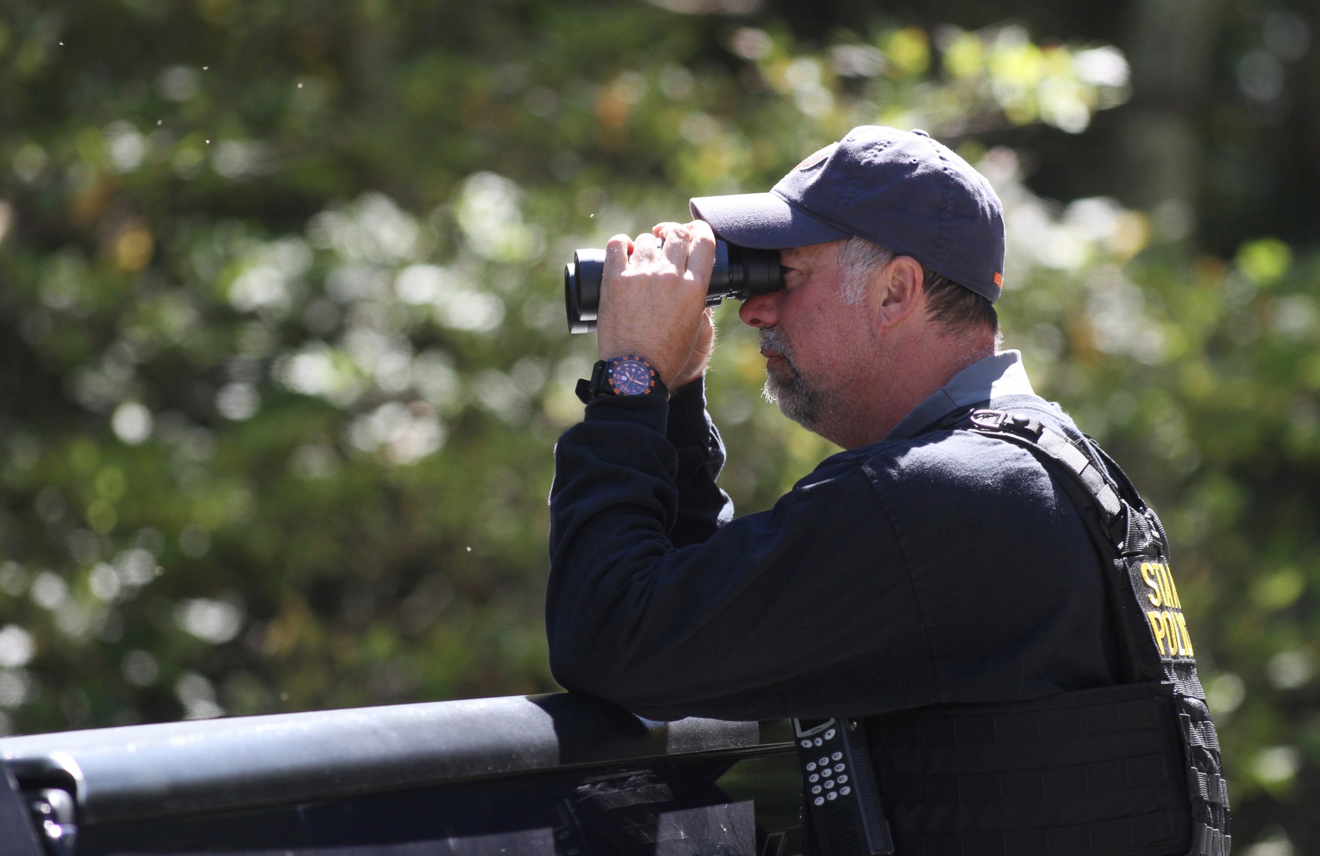 PHOTO: A Pennsylvania State Police trooper helps create a perimeter in the search area for Eric Frien near the intersection of in Canadensis, Pa, on Sept 23, 2014.