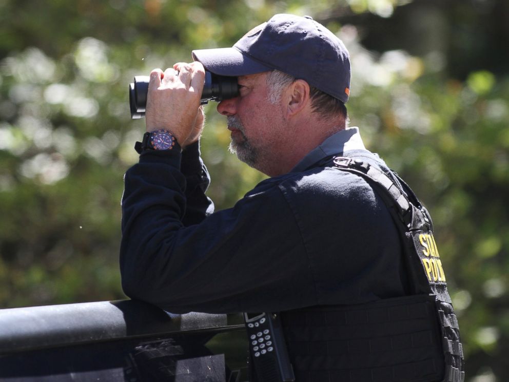 PHOTO: A Pennsylvania State Police trooper helps create a perimeter in the search area for Eric Frien near the intersection of in Canadensis, Pa, on Sept 23, 2014.