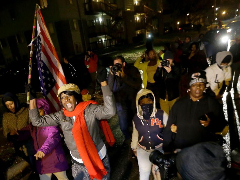 PHOTO: Protesters march Saturday, Nov. 22, 2014, along a stretch of road where violent protests occurred following the August shooting of unarmed black teenager by a white police officer in Ferguson, Mo.