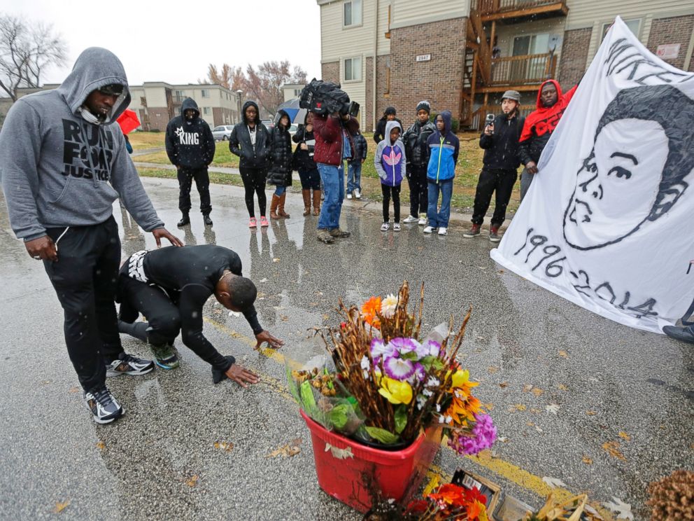 PHOTO: Ray Mills, left, and Londrelle Hall pause before a memorial in the middle of a street Sunday, Nov. 23, 2014, more than three months after a black 18-year-old was shot and killed there by a white policeman in Ferguson, Mo.
