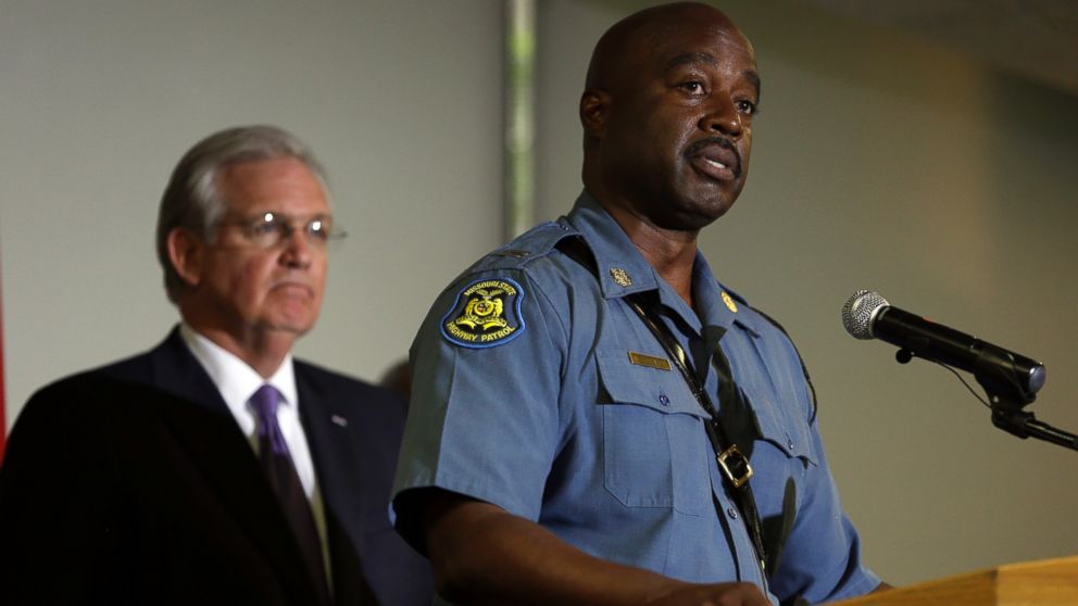Capt. Ron Johnson of the Missouri Highway Patrol speaks during a news conference as Missouri Gov. Jay Nixon listens during news conference on Aug. 14, 2014, in St. Louis.