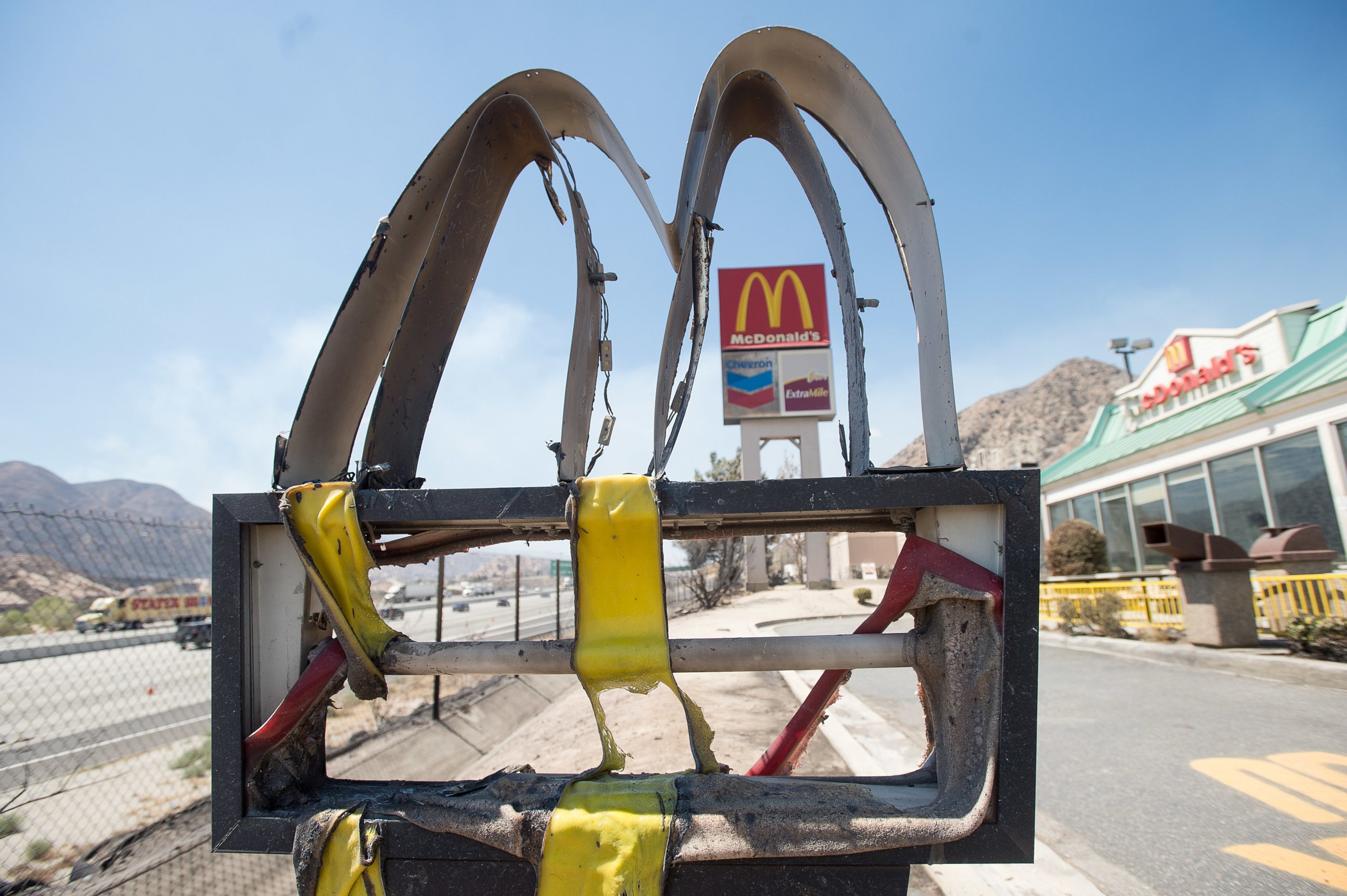 PHOTO: Following a wildfire, a melted McDonald's sign stands outside a restaurant in Cajon Junction, Calif., on Thursday, Aug. 18, 2016