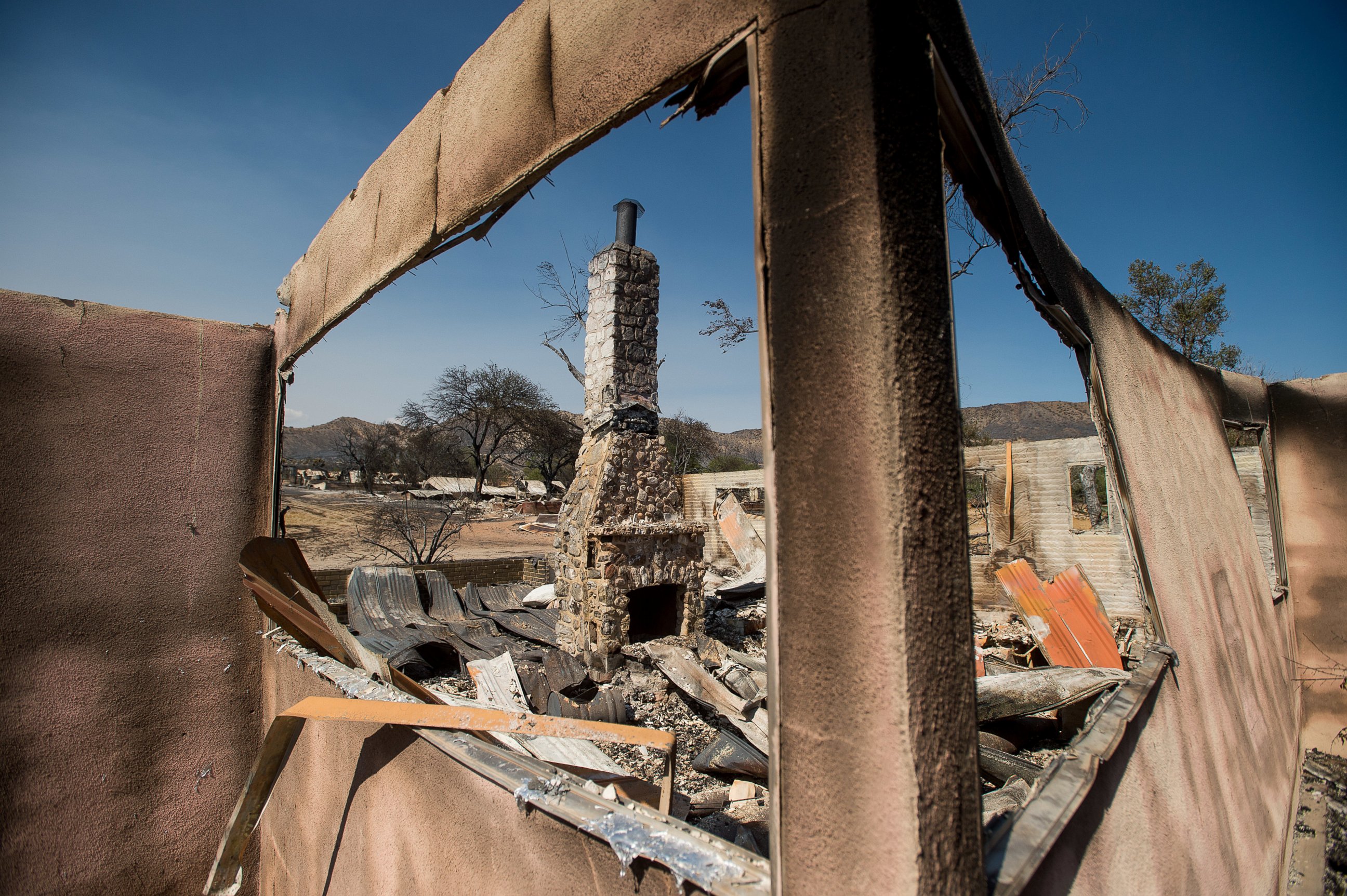 PHOTO: A chimney stands amid rubble at a house scorched by a wildfire in Phelan, Calif., Friday, Aug. 19, 2016. 