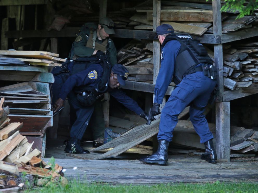 PHOTO: New York State Department of Corrections Officers and a forest ranger search a barn in Owls Head, N.Y. for convicted murderers Richard Matt and David Sweat, June 26, 2015.