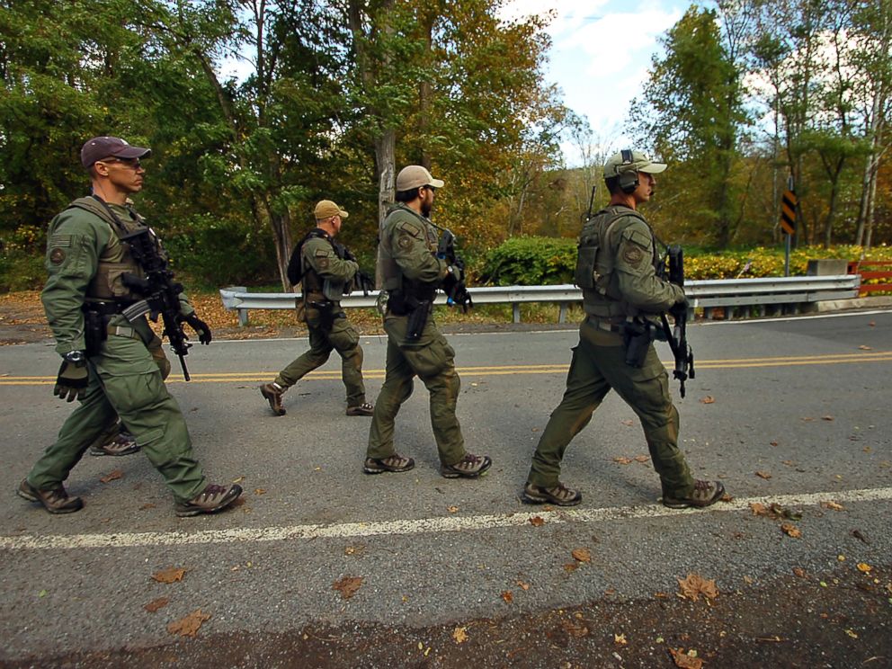 PHOTO: Members of the FBI SWAT team walk to the woods Oct. 8, 2014 in Price Township near Canadensis, Pa., searching for killer Eric Frein.