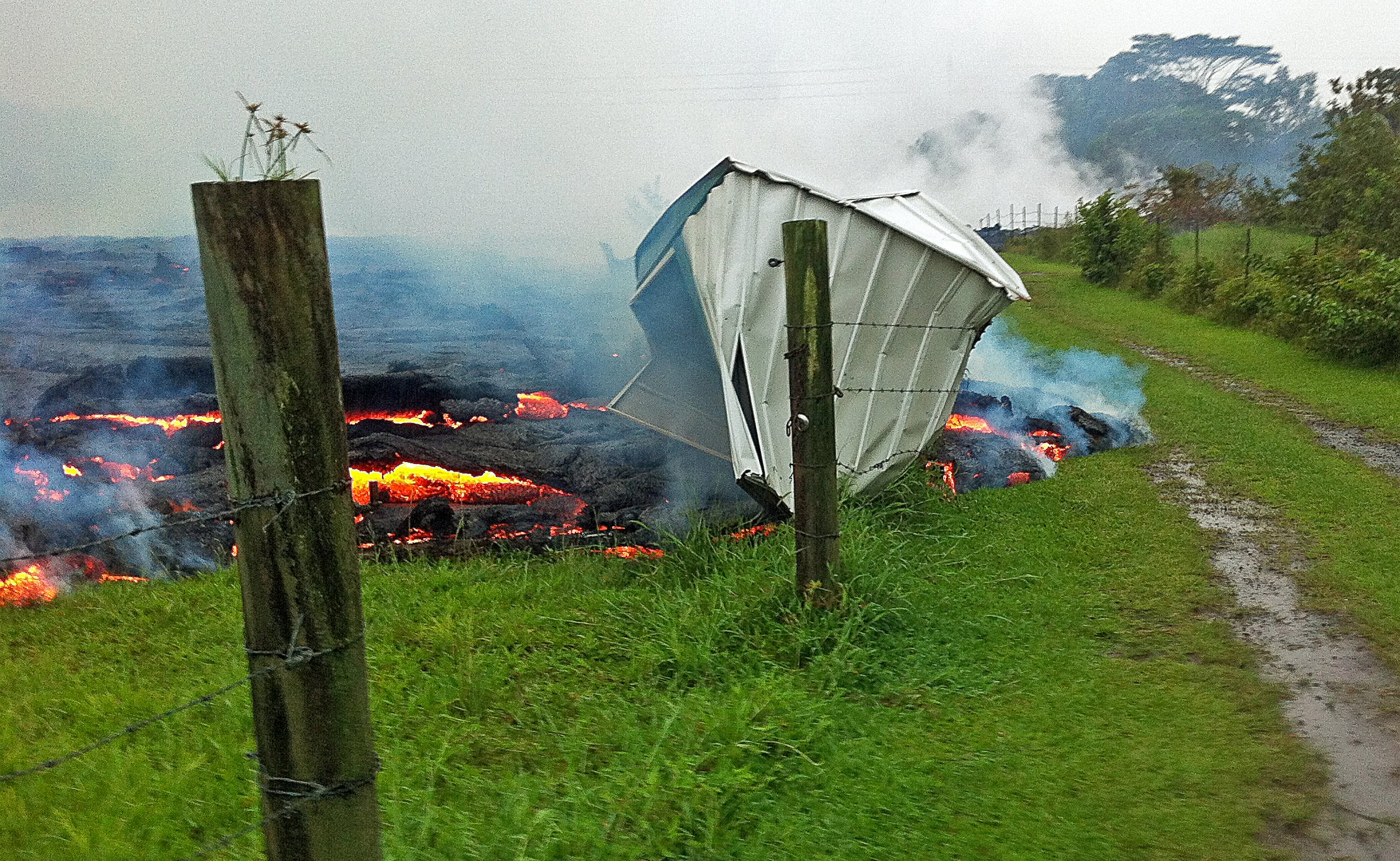 PHOTO: A small shed is consumed by lava in a pasture between the Pahoa cemetery and Apaa Street near the town of Pahoa on the Big Island of Hawaii, Oct. 25, 2014.