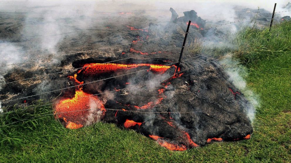PHOTO: Lava flow advances across the pasture between the Pahoa cemetery and Apaa Street, engulfing a barbed wire fence, near the town of Pahoa on the Big Island of Hawaii, Oct. 25, 2014.